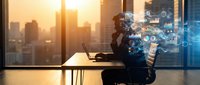 Professional businessman analyzing digital data analytics and financial charts in modern office with city skyline view during golden hour sunset.