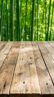 Wooden deck with blurred bamboo forest background, ideal for product placement, nature themes, and outdoor lifestyle designs.
