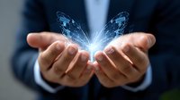Glowing blue butterfly hovering over cupped hands of business professional in dark suit, symbolizing transformation, hope and corporate innovation.