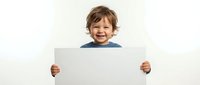 Happy toddler boy with curly brown hair holding blank white sign for customizable text and messages on clean background for advertising and promotional use.