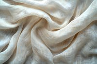 Soft waves of delicate white linen fabric with natural texture and gentle folds creating an elegant abstract pattern. Macro photography shows fine weave details.