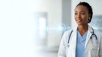 Young African American female doctor in white coat with stethoscope smiling confidently in modern hospital setting with digital interface elements.