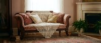 Elegant rolled-arm sofa with rust and cream upholstery in traditional living room setting with fireplace, ornate rug, and natural window light for interior design projects.
