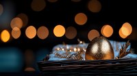 Golden Christmas ornament on dark woven basket with pine branches against blurred warm bokeh lights creating magical holiday atmosphere.
