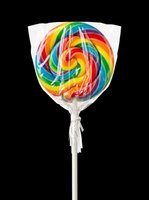 Colorful rainbow lollipop with swirled candy design on stick, isolated on transparent background. Ready for clipart, t-shirt designs, stickers, and print-on-demand products.