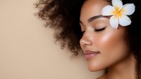 Young African American woman with natural curly hair and plumeria flower, eyes closed with serene expression against beige background, showcasing natural beauty and spa wellness.