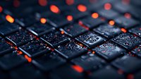 Wet computer keyboard with water drops illuminated by red and orange lights creating dramatic tech atmosphere. Close up macro photography with shallow depth of field.