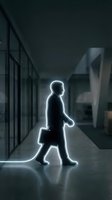 Glowing silhouette of businessman walking through modern office corridor with briefcase. Corporate professional illuminated with bright white light outline.