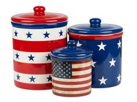 Patriotic ceramic canister set with red, white and blue striped and star patterns, featuring three lidded storage containers in varying sizes for kitchen organization and decor.