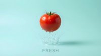 Fresh red tomato splashing in water against turquoise background, isolated for food and beverage design, advertising, packaging, and healthy eating concepts.