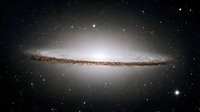 Spectacular edge-on spiral galaxy with bright central bulge and dark dust lanes against starry cosmic background for astronomy and space exploration.