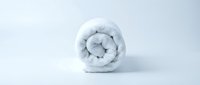 Rolled white towel isolated on white background, ready for spa, hotel, hospitality, and wellness design projects.