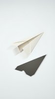 White paper airplane casting shadow on clean background symbolizing flight, travel, communication, and business success concepts.