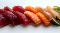 Fresh assorted nigiri sushi pieces with tuna, salmon and white fish arranged in diagonal row on white background, traditional Japanese cuisine presentation.