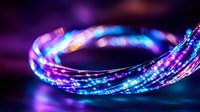 Glowing spiral light trail in vibrant neon blue and purple colors against dark background creates dynamic motion effect for technology and abstract designs.