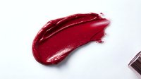 Red lipstick swatch on white background, cosmetic product sample for beauty and makeup design, advertising and packaging purposes.