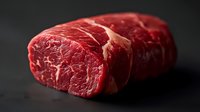 Raw beef steaks with marbled texture on dark background for culinary cooking and grilling recipes.