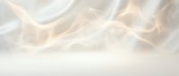 Soft flowing smoke or mist with warm golden light creating ethereal atmospheric background for luxury branding and elegant design projects.