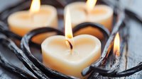 Heart-shaped candles with vanilla scent and black vanilla beans arranged on wooden surface, perfect for romantic occasions, spa relaxation, and home decor.