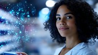 Young African American woman with curly hair smiling confidently in professional setting with bokeh lights and magical sparkle overlay effect creating dreamy atmosphere.