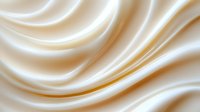 Smooth flowing cream silk fabric with elegant waves and soft golden highlights creating luxurious textile background for fashion and interior design projects.