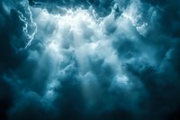 Dramatic sunbeams breaking through dark stormy clouds in turquoise tones create atmospheric mood for spiritual, religious and weather-related designs.
