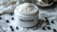 White protein powder in open jar with measuring scoop and blueberries on marble surface for fitness nutrition and healthy lifestyle supplements.