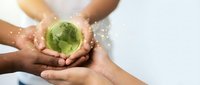 Diverse hands protecting green earth globe with sparkling light effects symbolizing global environmental protection and sustainability teamwork.