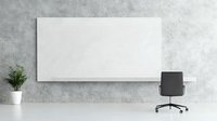 Minimalist office workspace with white rectangular board on concrete wall, black office chair and small decorative plant in white pot. Modern interior setup.