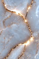 Ethereal marble texture with glowing golden cracks and sparkling stardust on pale blue background creates magical celestial pattern for luxury design projects.