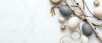 Easter eggs in neutral colors with birch branches and quail eggs on white background. Spring holiday decoration concept for greeting cards and seasonal design.
