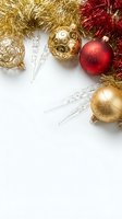 Festive Christmas ornaments with gold and red baubles, tinsel garland and crystal icicles on white background for holiday greeting cards and seasonal designs.