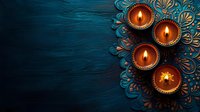 Traditional clay oil lamps with burning flames on decorative blue wooden background for Diwali festival celebration or spiritual ceremony.