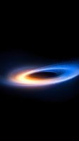 Glowing spiral of light against dark space background shows cosmic black hole with bright orange and blue accretion disk surrounded by stars and cosmic dust.