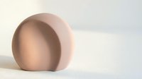 Minimalist beige ceramic dome sculpture with smooth curved surfaces and soft shadows, isolated on white background for design projects.