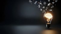 Glowing light bulb with science and technology icons floating above on dark background representing innovation, creativity and bright ideas for business solutions.