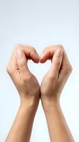 Two hands forming a heart shape gesture on a light background, symbolizing love, care, and support for health and charity concepts.