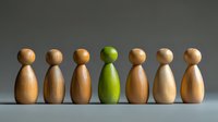 Wooden figures in row with one green figure standing out, representing uniqueness, diversity and leadership concept against neutral background.
