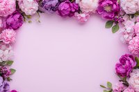 Pink and purple peony flowers create romantic frame border on soft pink background, fresh floral arrangement with green leaves for wedding design.