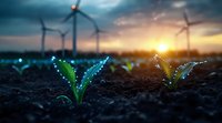 Young glowing plant sprouts emerge from soil at sunset with wind turbines in background, symbolizing sustainable energy and environmental conservation.