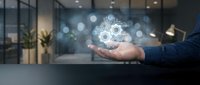 Businessman hand presenting glowing gear mechanism hologram in modern office environment representing innovation and technology solutions.