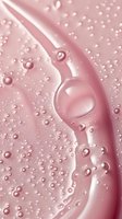 Macro shot of pink cosmetic cream texture with water droplets and bubbles creating abstract swirling pattern on smooth surface. Suitable for beauty industry.