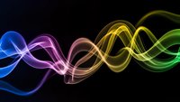 Abstract colorful wave lines flowing horizontally with neon glow effects on black background for modern digital design projects and presentations.
