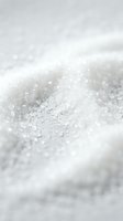 Macro close-up of white granulated sugar crystals with shallow depth of field, ideal for food, baking, and culinary design projects.