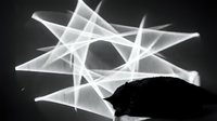 Abstract geometric light trails forming star pattern over silhouetted mountain landscape in monochrome composition for modern design projects.