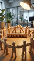 Wooden figures collaborating around synergy text blocks on office desk, representing teamwork, cooperation and business partnership in modern workplace environment.