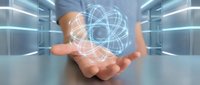 Businessman holding glowing atomic structure hologram in modern data center representing nuclear energy, quantum physics and scientific innovation concepts.