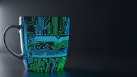 Electronic circuit board pattern coffee mug with glowing green and blue microchip design for tech enthusiasts and programmers.
