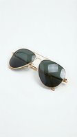 Stylish aviator sunglasses with gold metal frame and dark green lenses on white background for fashion and eyewear accessories.