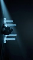 Silhouetted figure climbing glowing neon platforms in dark space with dramatic light rays, representing ambition, progress, and digital transformation for business and technology concepts.